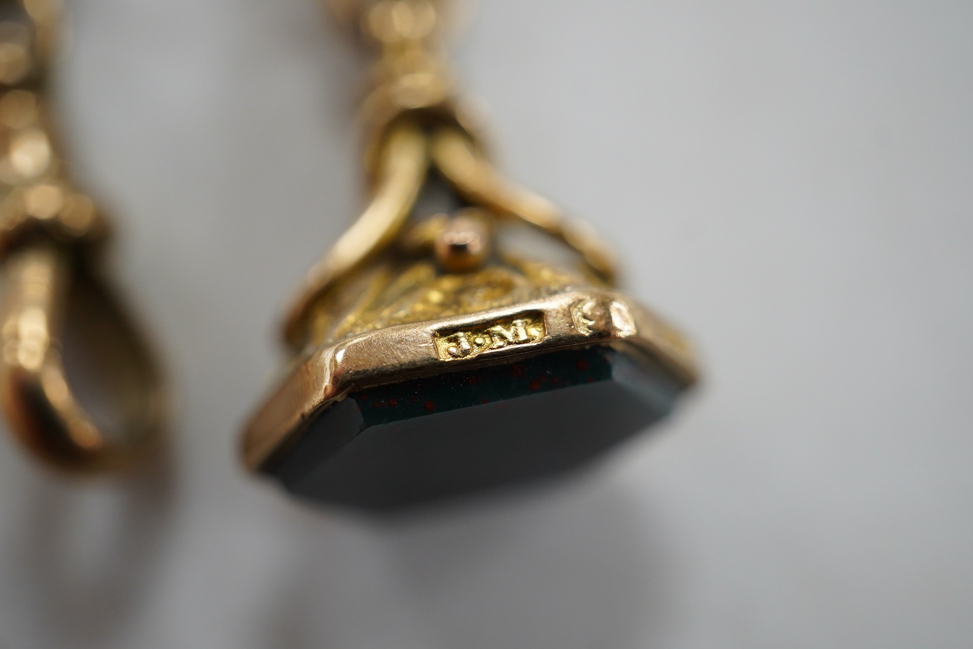 A late Victorian 9ct albert, hung with a late Victorian 9ct gold and bloodstone set fob seal, 23cm, gross weight 12.2 grams. Condition - fair